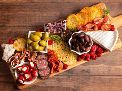 A stock image of a charcuterie board on a wooden table