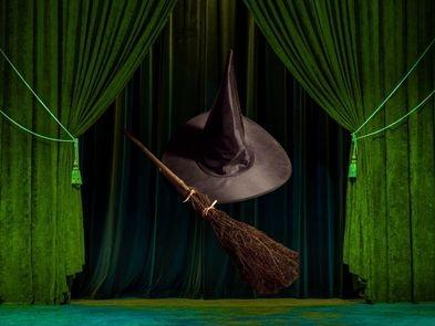 Green background with witches hat and broom