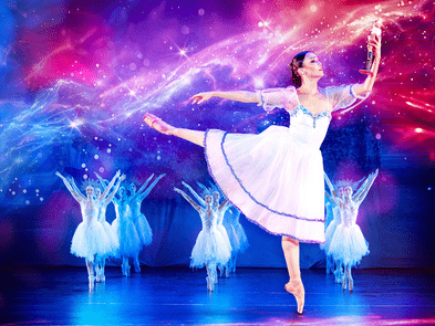 Ballerina, holding a nutcracker, with her leg extended behind her in arabesque