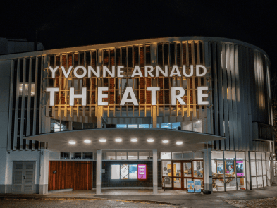 At night, outside the front of the theatre. 