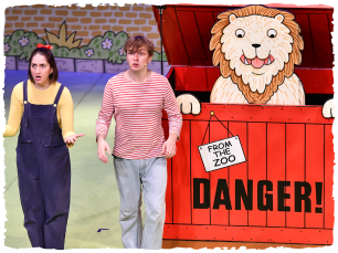 2 people with a lion in a red box