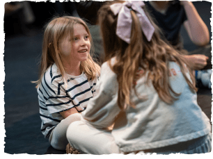 2 girls sat facing eachother