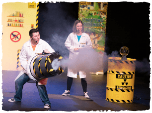 A smoke cannon held by one of two performers dressed as scientists