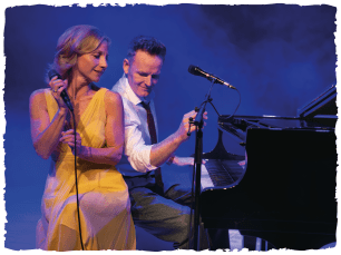 Pulman singing, Stilgoe on piano