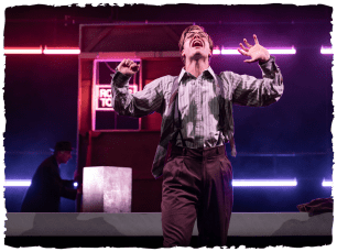 Man with arms up looking like he is crying or shouting with a background of fluroescent lights