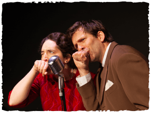 Man and Woman speaking in to a mic, wiping their lips