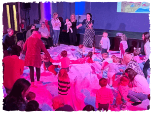 Children and adults in big circle