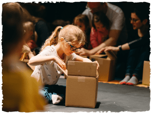 Child looking in cardboard box