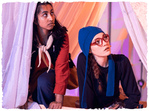 two actors inside a tent