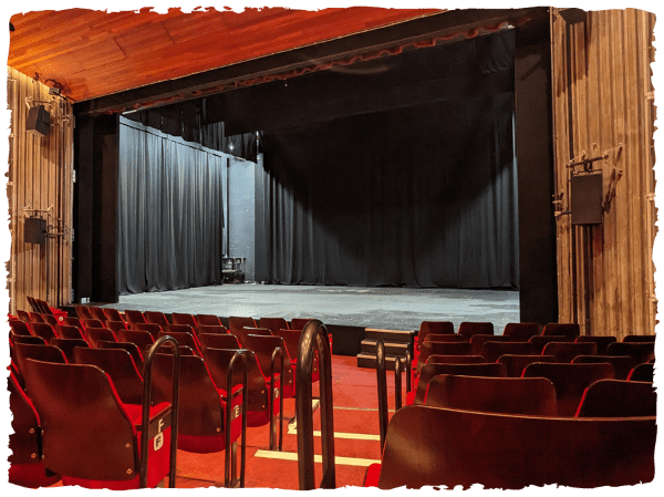 View of main house empty stage from seat in auditorium