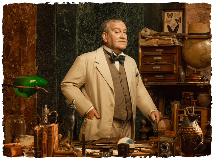 An actor dressed as Hercule Poirot standing behind a desk