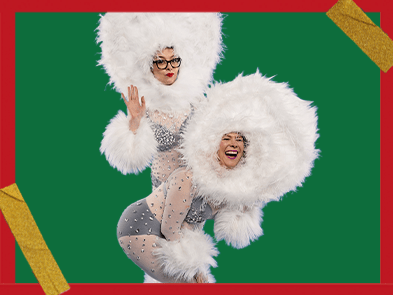 Helen Thorn and Ellie Gibson dress in a fluffy white outfit in front of a green background with golden tape sticking on red borders