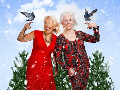 Dillie Keane and Barb Jungr holding two turtle doves while stood next to each other