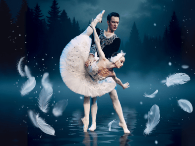 Two ballet dancers, one being held by the other in a pose