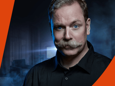 Rufus Hound and an orange swish at the top and bottom of the image
