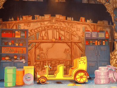 A garage scene with a prop car